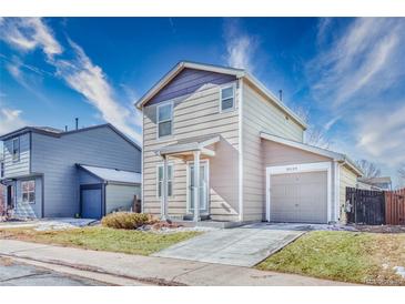 Charming two-story home with a well-manicured lawn and attached one car garage at 10129 Glencoe Ct, Thornton, CO 80229