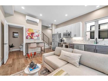 Bright, open-concept living space with modern kitchen, stainless steel appliances and stylish decor at 3219 W 19Th Ave # 3, Denver, CO 80204