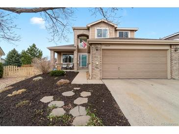 Charming two-story home with a well-manicured lawn and inviting facade at 2805 Masters Ln, Castle Rock, CO 80104