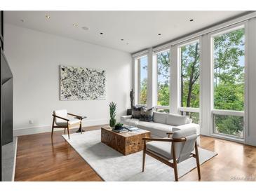 Bright living room with hardwood floors, large windows, and stylish furniture at 1804 Little Raven St, Denver, CO 80202