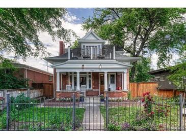 Charming two-story home featuring a red brick facade, front porch, and balcony at 3779 Quitman St, Denver, CO 80212