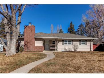 Charming single-story home with a red brick chimney and walkway leading to the front door at 2061 E Floyd Ave, Englewood, CO 80113