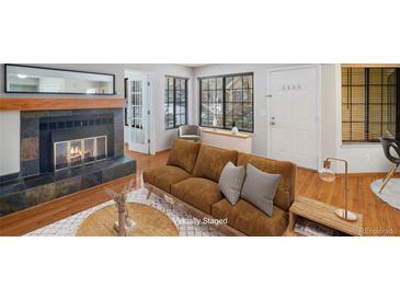 Virtually staged living room with fireplace at 4862 E Kentucky Ave # D, Denver, CO 80246