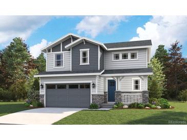 Charming two-story home with a gray garage door, blue front door, a welcoming porch, and professional landscaping at 8295 Snake River St, Littleton, CO 80125