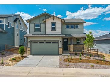 Charming two-story home boasts a well-manicured front yard, stone accents, and a welcoming front porch at 8295 Snake River St, Littleton, CO 80125