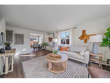 Bright living room features hardwood floors, and neutral color palette, creating a cozy atmosphere at 3730 Miller Ct, Wheat Ridge, CO 80033