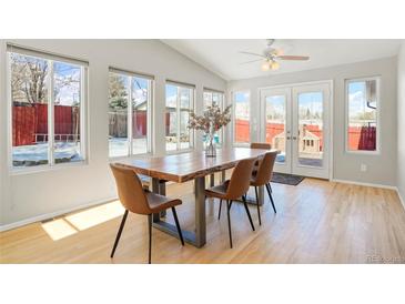 Bright dining area with a live-edge table and access to the backyard at 1557 S Pierson St, Lakewood, CO 80232