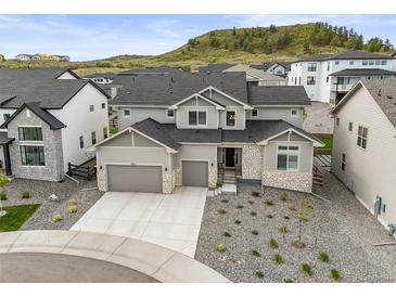 Beautiful two-story home with a three-car garage and stone accents at 5411 Edenborn Way, Castle Rock, CO 80104