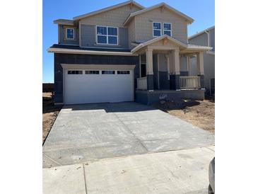 Two-story home with a two-car garage, covered porch, gray siding, and a concrete driveway at 664 Deer Park, Watkins, CO 80137