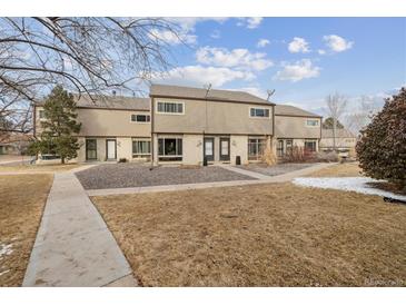 Charming townhome with beautiful landscaping, stone front, and classic architectural details at 4641 W Ponds Cir, Littleton, CO 80123