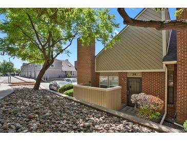 Charming brick townhouse with a well-maintained front yard and mature landscaping at 3300 W Florida Ave # 26, Denver, CO 80219