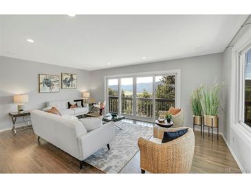 Bright living room featuring hardwood floors, mountain views, and neutral furnishings at 258 Post Boy Rd, Boulder, CO 80302