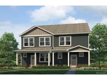 New two-story townhome with modern architecture and manicured front lawn at 1380 S Boston Ct # A, Denver, CO 80247