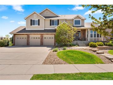 Charming two-story home featuring a three-car garage and well-manicured landscaping at 27290 E Nova Cir, Aurora, CO 80016