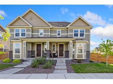 Charming townhome with a welcoming front porch and well-maintained landscaping at 17692 Olive St, Broomfield, CO 80023