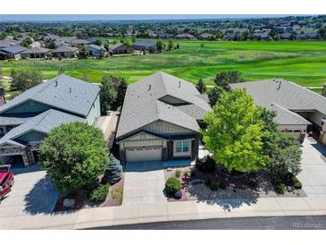 Beautifully landscaped home with a well-maintained yard backing onto a golf course at 15088 Verbena St, Thornton, CO 80602
