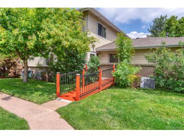 Charming home featuring well-maintained landscaping and an inviting entryway bridge at 3351 S Field St # 191, Lakewood, CO 80227