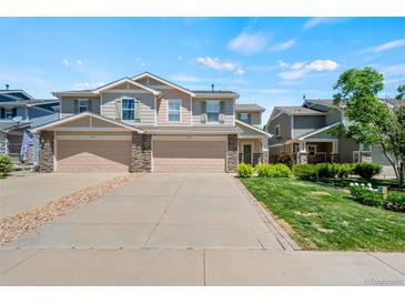 Charming townhome featuring stone accents, a two-car garage and well-maintained landscaping at 6139 Raleigh Cir, Castle Rock, CO 80104