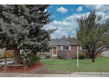 Charming brick home featuring a well-maintained front yard with mature trees under a bright sky at 4391 W Tufts Ave, Denver, CO 80236