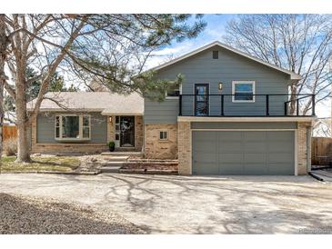 Charming two-story home with a two car garage, brick accents, neutral paint, and upper deck at 8025 S Cody St, Littleton, CO 80128