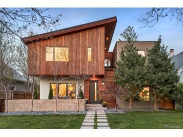Contemporary exterior featuring wood siding, modern design, and professionally landscaped front yard at 1452 S Washington St, Denver, CO 80210