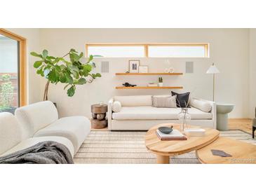 Cozy living room with stylish decor, comfortable seating, and plenty of natural light at 1452 S Washington St, Denver, CO 80210