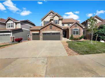 Charming two-story home with stone accents, three-car garage, and well-maintained landscaping at 2180 Trailblazer Way, Castle Rock, CO 80109