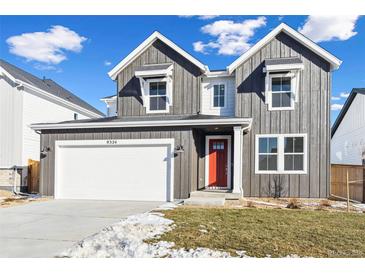 Two-story farmhouse-style home with gray siding, red door, and a white garage at 9324 Quartz St, Arvada, CO 80007
