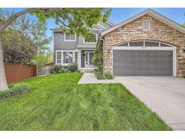 Charming two-story home with stone accents, lush lawn, and a well-maintained, inviting exterior at 16341 Maple Rock Ct, Parker, CO 80134