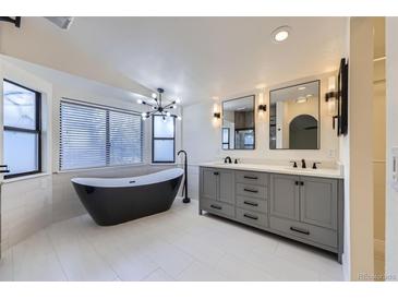 Modern bathroom featuring a freestanding tub, double sink vanity, and updated fixtures at 11892 Vallejo St, Denver, CO 80234