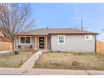 Charming single-story home with a cozy front porch and manicured lawn at 2713 S Hazel Ct, Denver, CO 80236