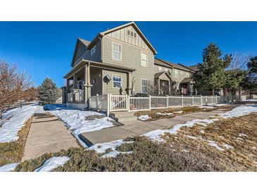 Two-story home with white picket fence, snowy yard, and sidewalk at 3805 Windriver Trl, Castle Rock, CO 80109