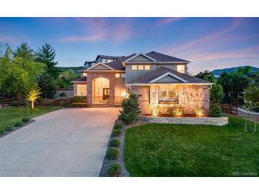Stunning brick and stucco home with an inviting entrance and manicured front yard at 5364 Dunraven Cir, Golden, CO 80403