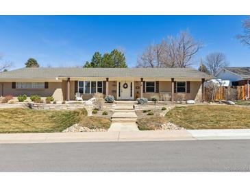Charming single-story home featuring a landscaped front yard with a welcoming entrance and inviting curb appeal at 6902 S Jackson Way, Centennial, CO 80122