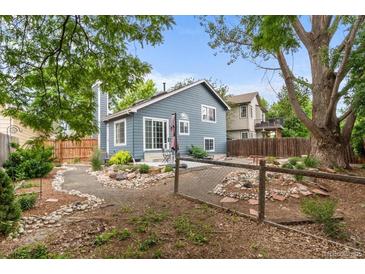 Charming home featuring a beautiful backyard area with rock garden, fence and patio seating at 13341 Birch Cir, Thornton, CO 80241