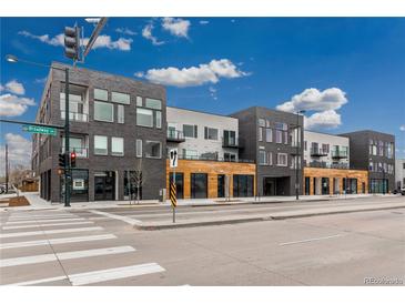 Modern multi-unit building with sleek architecture, wood accents, and street-level commercial spaces at 1616 S Broadway # 206, Denver, CO 80210