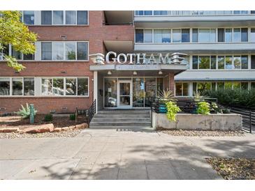 Inviting entrance of Gotham, a multi-story brick building, featuring modern architectural accents and landscaping at 1196 N Grant St # 407, Denver, CO 80203