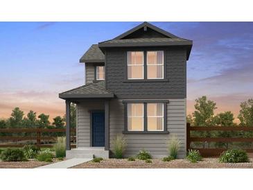 Charming two-story home with a covered porch, neutral siding, and a well-manicured front yard at 14877 Arbor W Blvd, Thornton, CO 80602