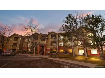 Multi-Gathering home with brick and siding facade, mature trees, and parking at sunset at 8422 S Upham Way # G47, Littleton, CO 80128