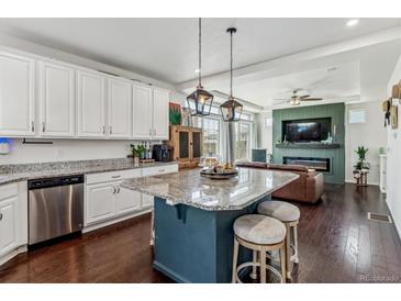 Beautiful, modern kitchen with a large island, granite countertops, and stainless steel appliances at 10560 Waco St, Commerce City, CO 80022