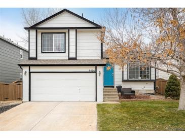 Two-story house with white siding, blue door, and attached garage at 9506 Castle Ridge Cir, Highlands Ranch, CO 80129