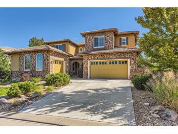 Stunning two-story home featuring a spacious driveway and attached garage at 10631 Autumnsong Ct, Highlands Ranch, CO 80126