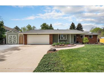Charming single-story home with well-manicured lawn and attached garage at 10482 W 75Th Ave, Arvada, CO 80005