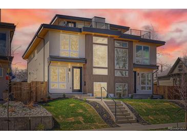 Modern duplex featuring a rooftop deck, large windows, and a well-manicured front yard at 4211 Vallejo St, Denver, CO 80211