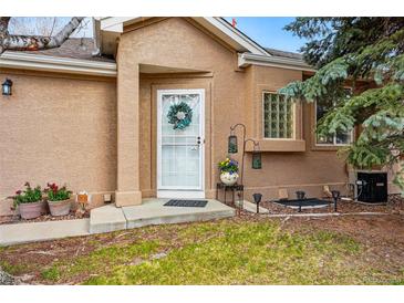Inviting home entrance featuring a decorative wreath and well-manicured landscaping at 12610 E Wesley Pl, Aurora, CO 80014