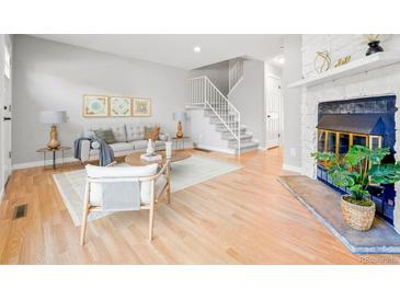 Bright living room with fireplace and hardwood floors at 1649 S Ivory Cir # K, Aurora, CO 80017