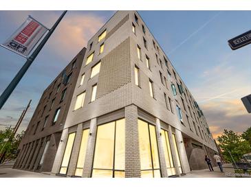 Modern multi-story apartment building featuring stylish brickwork and ample natural light from large windows at 603 Inca St # 530, Denver, CO 80204