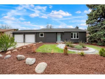Charming single-story home featuring a two-car garage and a manicured front yard with beautiful landscaping at 129 Gordon Pl, Castle Rock, CO 80104