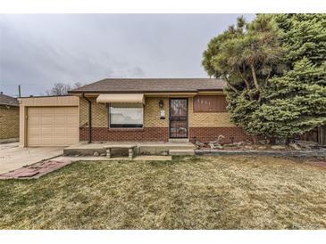 Charming brick home with a well-maintained front yard and a detached garage at 7251 Larsh Dr, Denver, CO 80221