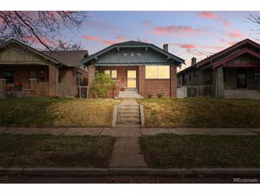 Charming brick home with a well-maintained front yard and a welcoming entrance at 618 Adams St, Denver, CO 80206